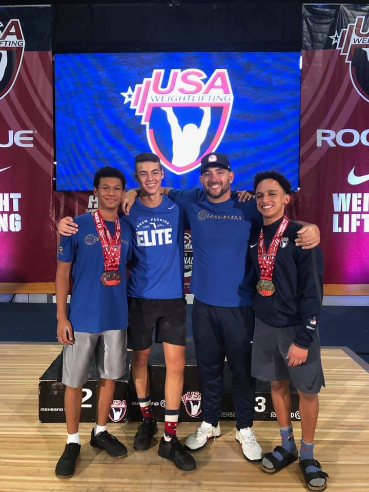 Coach Brian with athletes at a USA Weightlifting competition