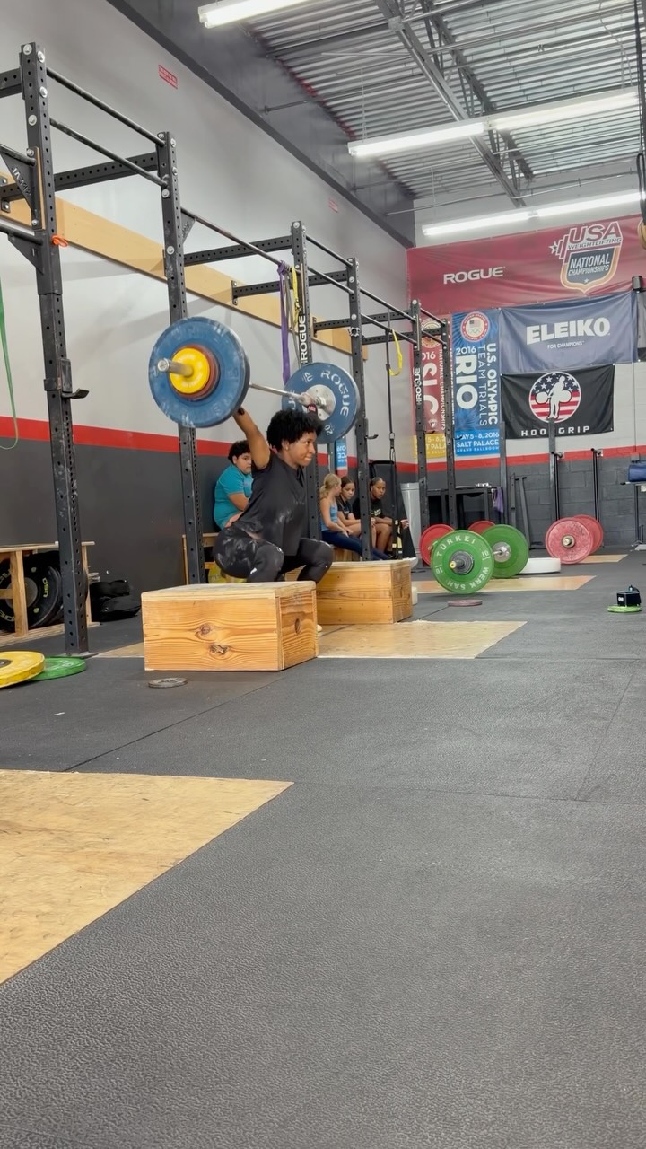 Athlete practicing a snatch progression in the gym