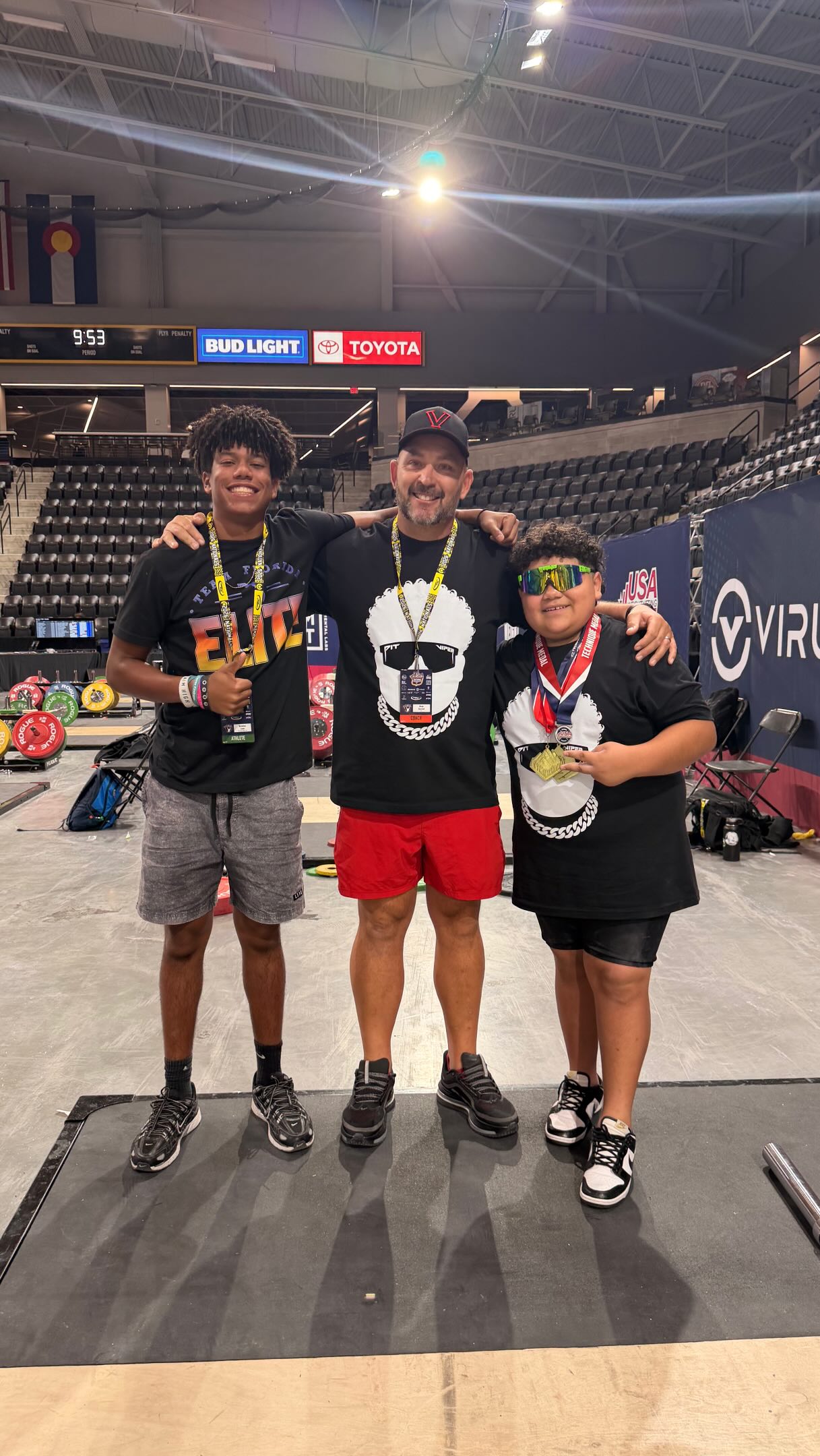 Coach with Vero Beach Weightlifting athletes and their medals